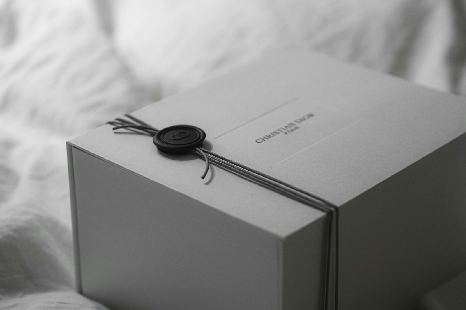 A white package tied with black ribbon