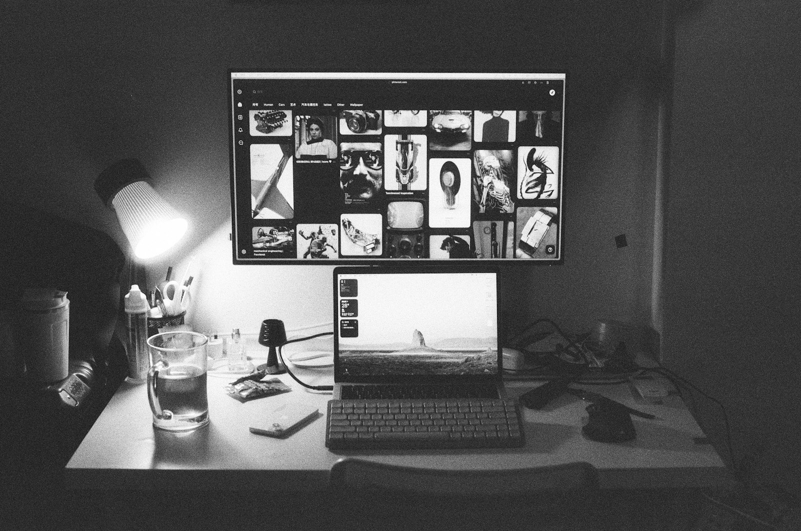 A monochrome workstation with a laptop and external display