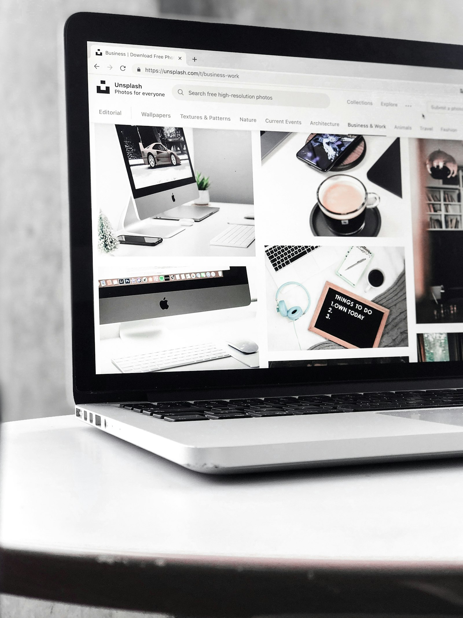 A minimal laptop workspace viewed in monochrome